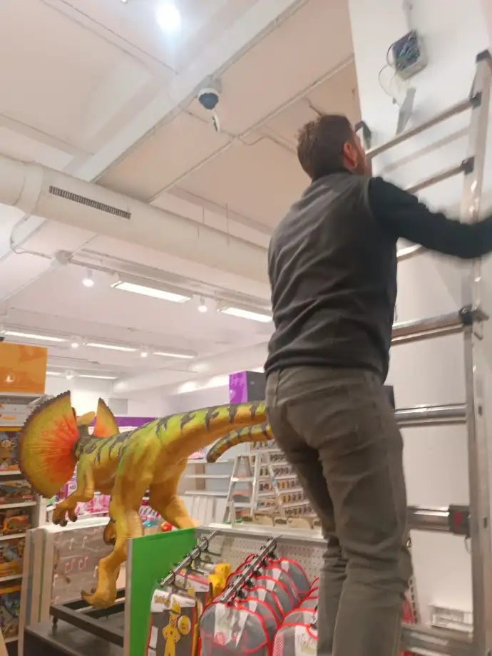 Trabajador de Aingenia en Toys´r us subiendo una escalera